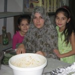 Abdallah's wife Majida and daughters Louma (8) and Layam (8) during preparations for Eid.