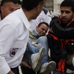 Medics carry an injured protester during clashes between protesters and Israeli forces at a demonstration marking Land Day, at Qalandiya checkpoint Ramallah on March 30. (Reuters/Darren Whiteside)