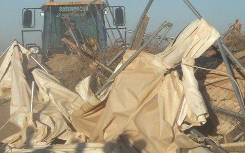 Caterpillar Bulldozer demolishing tents donated to the residents of Susiya as emergency aid by the U.N.