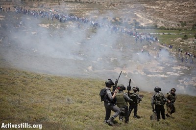 Israeli military shooting tear gas at protesters. Photo credit: Activestills
