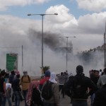 Protesters standing away from the tar gas (Photo by ISM)
