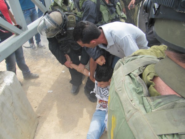Soldiers attempting to arrest young man trying to access his land