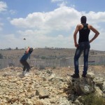 Youth from Ni'lin with the Apartheid Wall visible in the background