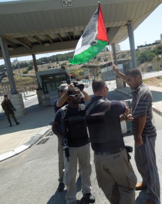 Protester being harassed by Israeli military in front of checkpoint