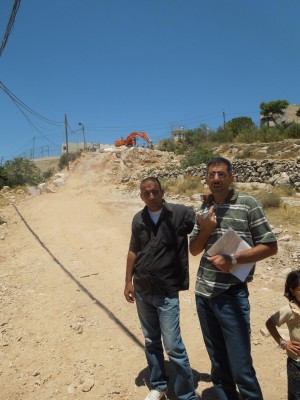 Palestinian landowners explain the destruction of their land (Photo by: ISM)