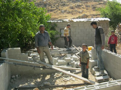 Residents of Ad Dawa around the demolished building (Photo by Ad Dawa municipality)