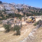 Bulldozers clear the path for the construction of the illegal settler road