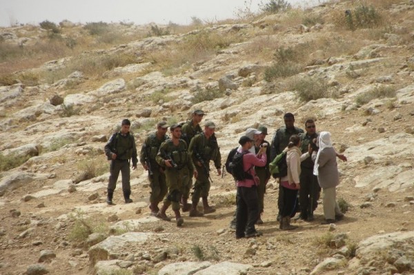 Palestinian shepherd arguing with Israeli border police officers just before he was detained (Photo by Operation Dove)