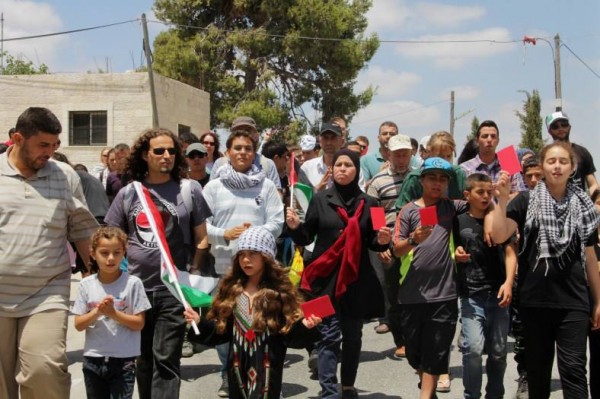 Protesters marching at last Friday demonstration in Nabi Saleh (Photo by Tamimi Press)