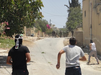 Youth of the village facing the force of the Israeli military