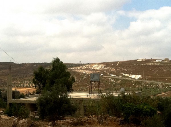 The illegal outpost of Havat Gilad on the right and the burnt land on the left (Photo by ISM)