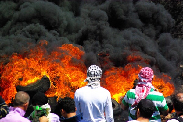 Protesters burning tyres, the smoke of which blew towards the illegal settlement of Qedumim (photo by Svenson Berger)