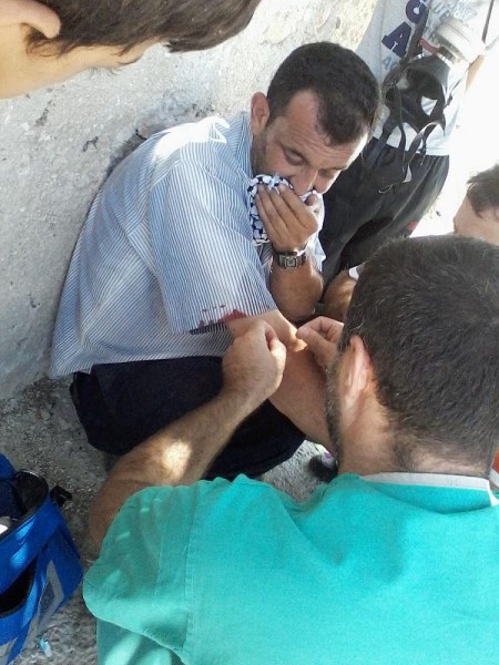 Protester treated by medic after being hit by teargas canister