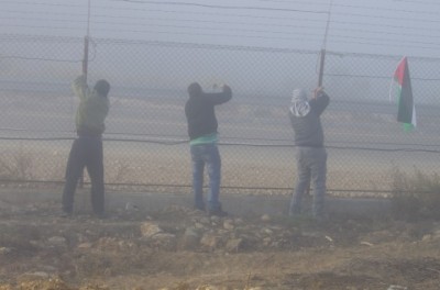 Palestinian activists began to cut down the annexation fence (photo by Ingrid Bousquet)