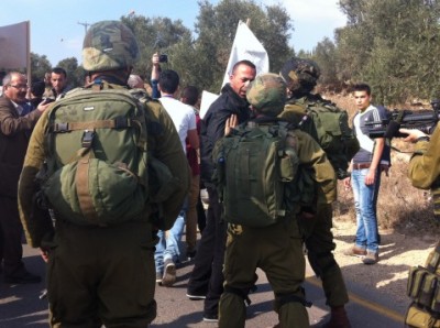 Israeli forces attempt to end the peaceful demonstration (photo by ISM).