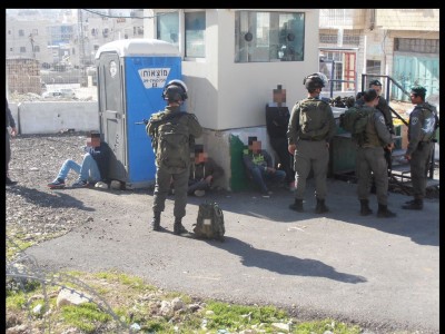 Four youth detained by the checkpoint ( Photo via ISM archives)