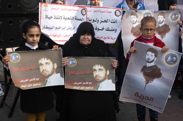 Umm Muhammad, the mother of critically ill prisoner Ibrahim Bitar, with two of his neices at a weekly sit-in. She hasn’t seen her son in more than three months. (Joe Catron)