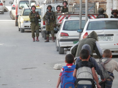 Israeli soldiers close to a school in Hebron (photo by ISM)