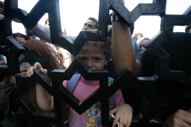 Palestinian-Egyptians wait to enter the Rafah border crossing, the only border through which Palestinians can exit Gaza