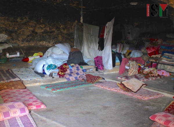 Inside one of the caves. Mattresses get spread around the floor in the evening to chat, share meals, watch tv and lay their heads.  
