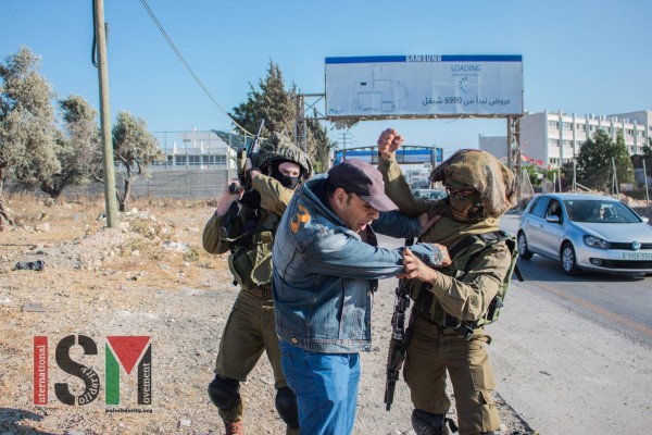 Soldiers beating a Palestinian man