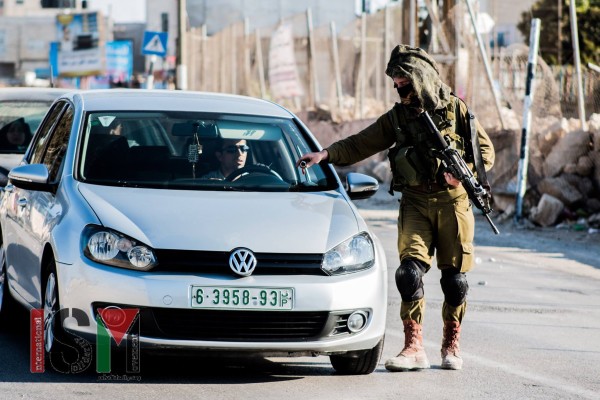Soldier taking the keys of a Palestinian's car