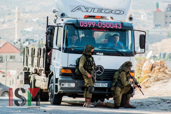 Israeli soldiers using a truck with passengers as a shield