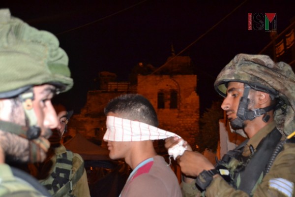 The soldier handcuffed and blindfolded a Palestinian young man