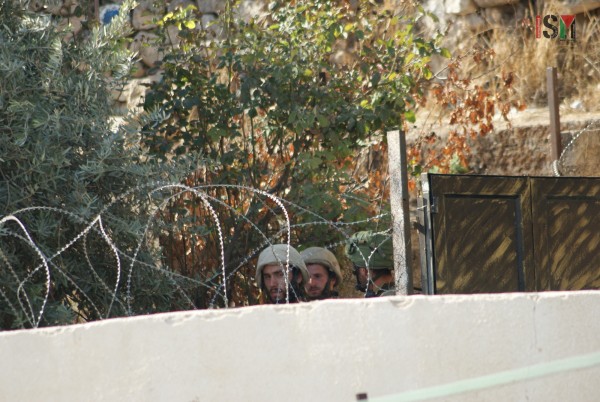 Israeli forces blocking the entrances to a Palestinian house