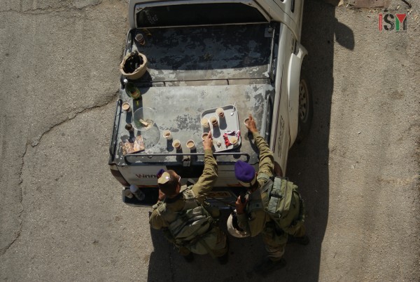Israeli soldiers having tea brought by settlers