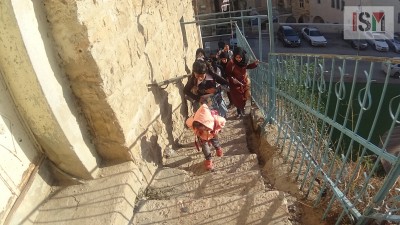 School-children climbing the stairs to their school