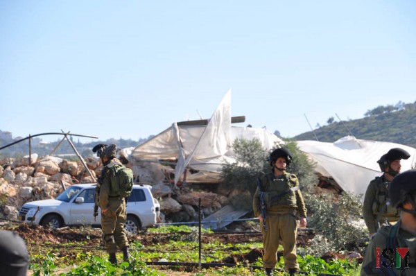 Settlers from the nearby settlements and soldiers watched the scene
