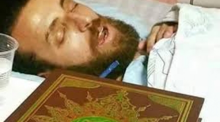 Journalist, Mohammed al-Qiq, in his hospital bed on the brink of death.