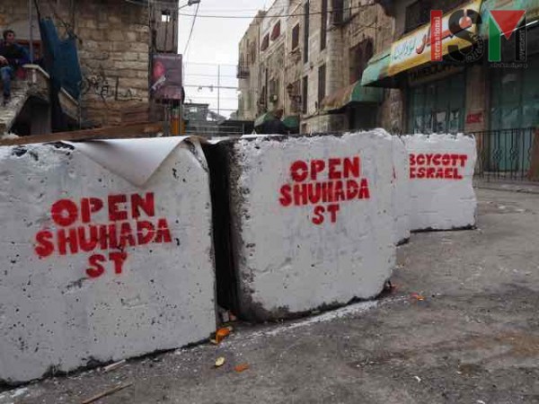 Anti-occupation murals on military blockade