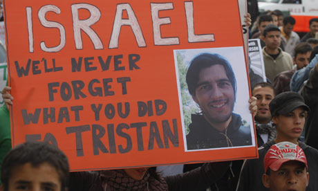 Protesters hold up a sign for Tristan