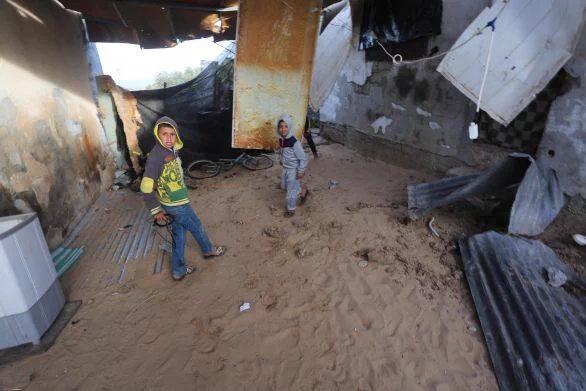 Children in the war torn buildings left by Israeli forces