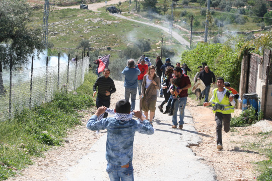 Demonstrators retreating from tear gas