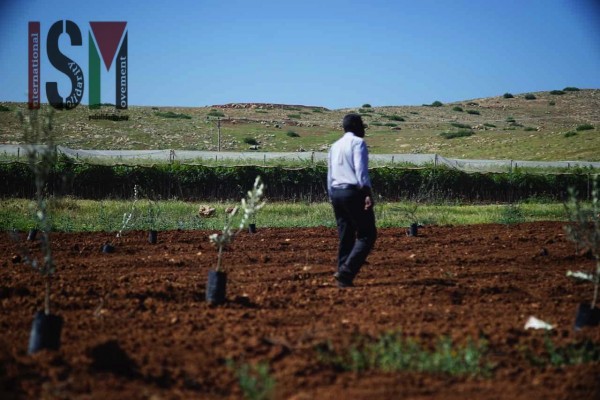 A man in the new field with the Israeli field behind him