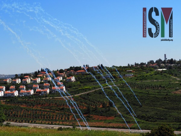 Tear gas rains down on Nabi Salih while behind sits the illegal Hamalish settlement 