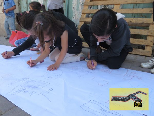 Children drawing outside Shuhada checkpoint, the 'entrance' to the closed military zone