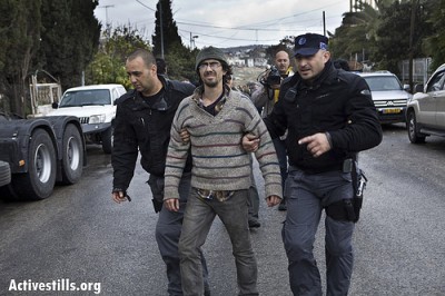 A demonstrator is arrested by Israeli police during a demonstration against Jewish settlements and in solidarity with Palestinian families who were evicted from their homes in the Sheikh Jarrah.