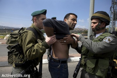 Marwan Farrarjah shows marks on his back after he was violently arrested by Israeli soldiers