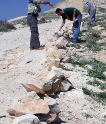 Palestinians build a wall near Jubbet Adh Dhib to prevent further land confiscation from an illegal settlement outpost.