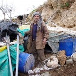 ... AND AFTER. Rafi Mahmoud Hanani with the wreckage of his animal shelter.