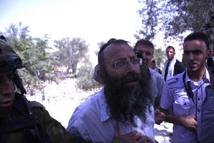 As settlers disrupt olive harvest, Israeli officer declares: “I am the law, I am God.”