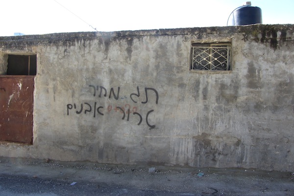 Graffiti in village of Yasouf, reading ‘Price tag; stone terror’, 18 February 2013 (Photo via: Abed Al-Karim a-Saadi/B’Tselem)
