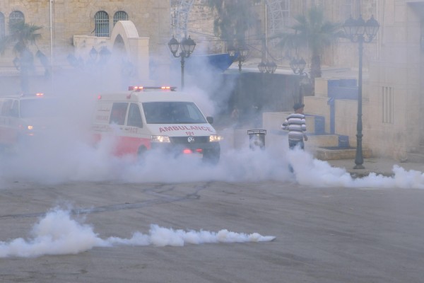 Ambulances drive back and forth through the demonstration