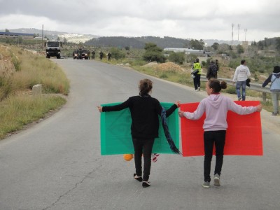 Young protesters walking towards the Israeli military