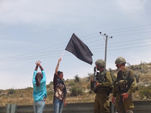 Residents of Nabi Saleh confront soldiers blocking them from reaching their stolen well 
