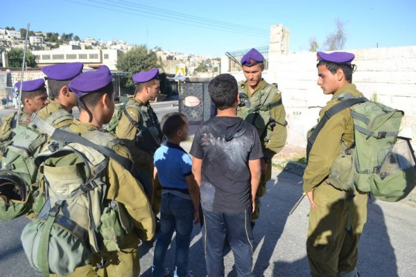 Soldiers surround children after their four hour detention